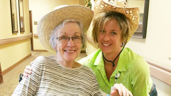 COTA Robin Vigil poses with Anthem Memory Care resident