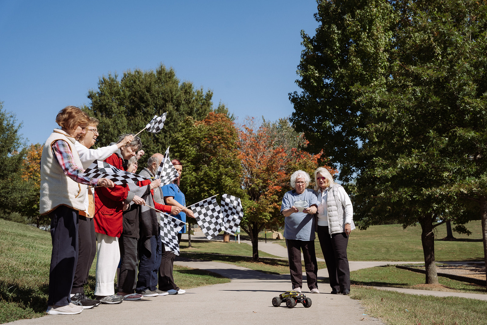 Concord Place residents holding race flags and car racing