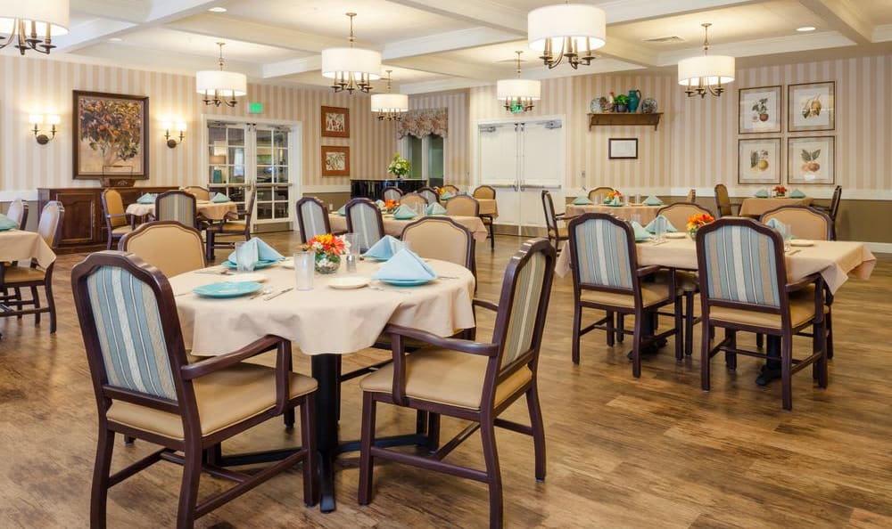 Wide open dining hall with hardwood flooring at Elk Ridge in Maplewood, Minnesota