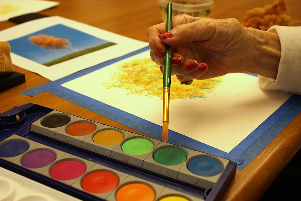 Resident painting at senior living in KS