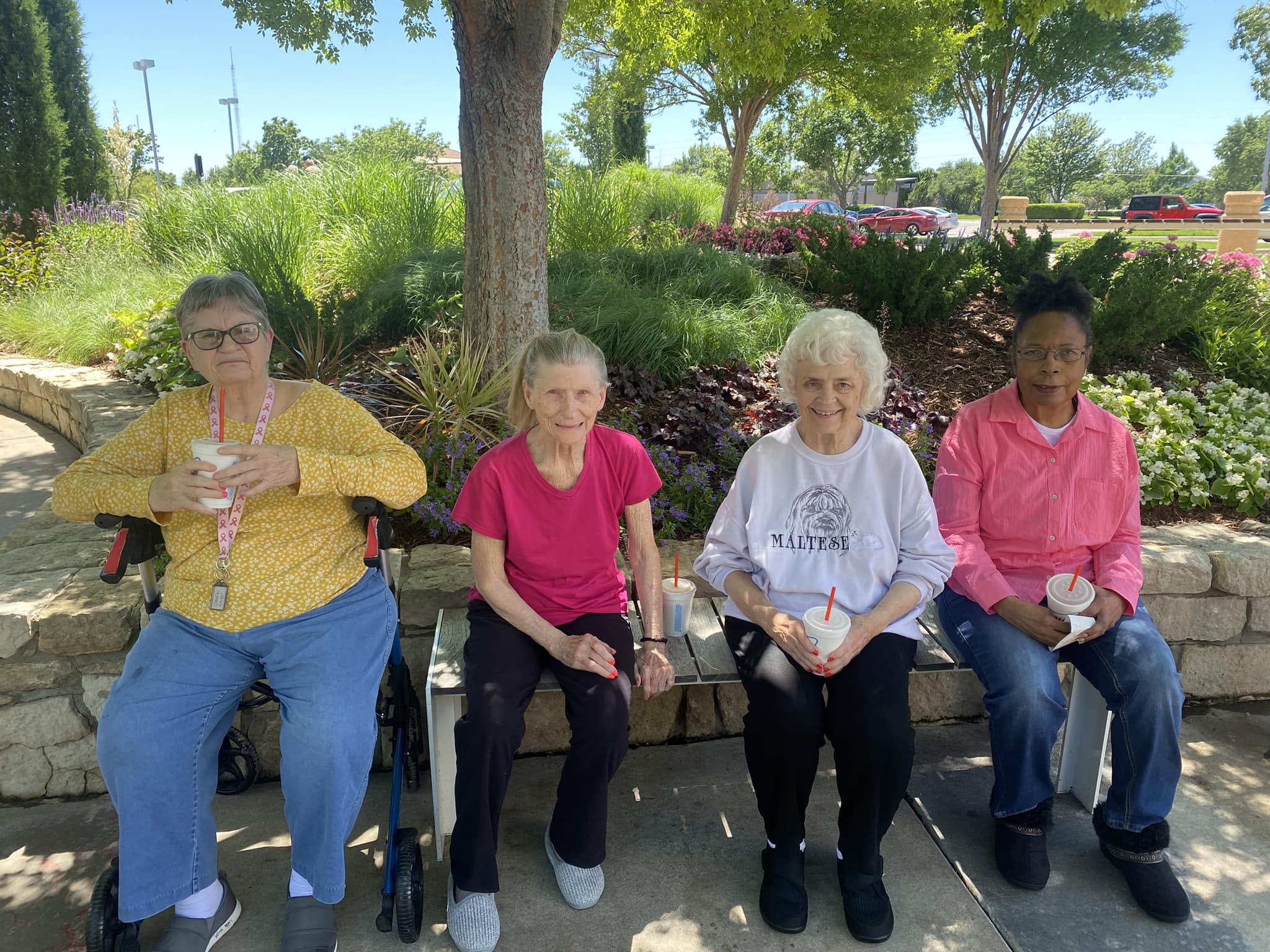 Chisholm Place residents sitting outside and enjoying the warm weather