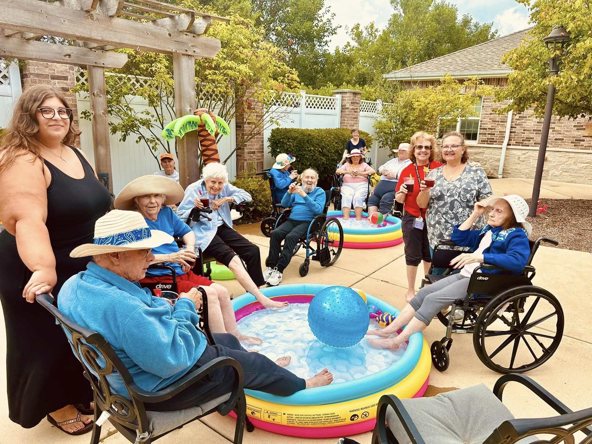 Churchill Place residents enjoying a day outside with feet in a pool