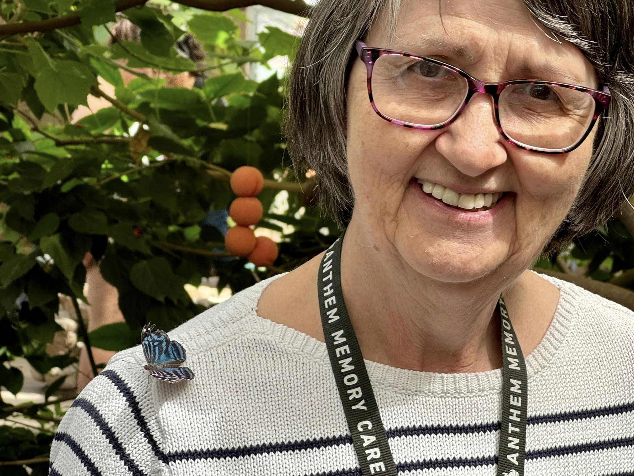 Willowbrook Place resident with a butterfly on her shoulder