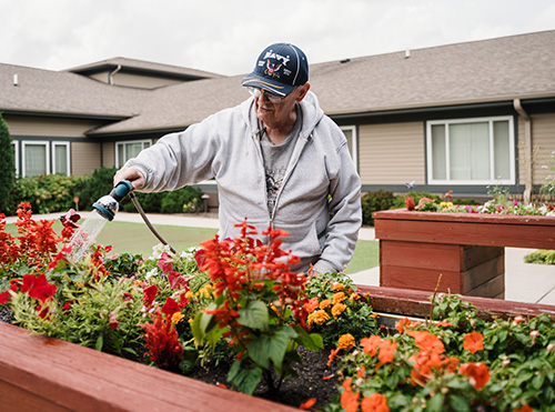 Resident from Harvester Place tending to the garden